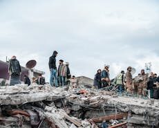 People inspect rubble after an earthquake in Jindires, Aleppo Governorate, Syria.